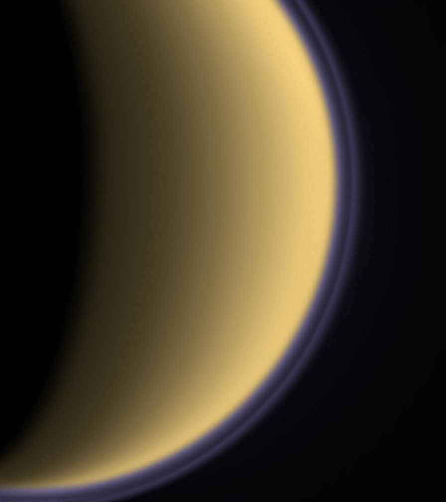 Surrounded by blue-violet stratospheric layers of methane, Saturn's moon Titan appears bathed in a gentle, sand-yellow colour. In January 2005, the European probe Huygens will touch down on the mysterious, completely cloud-covered moon and transmit images and data from the surface to Earth via the Cassini orbiter (Crediti: NASA/JPL/Space Science Institute.)